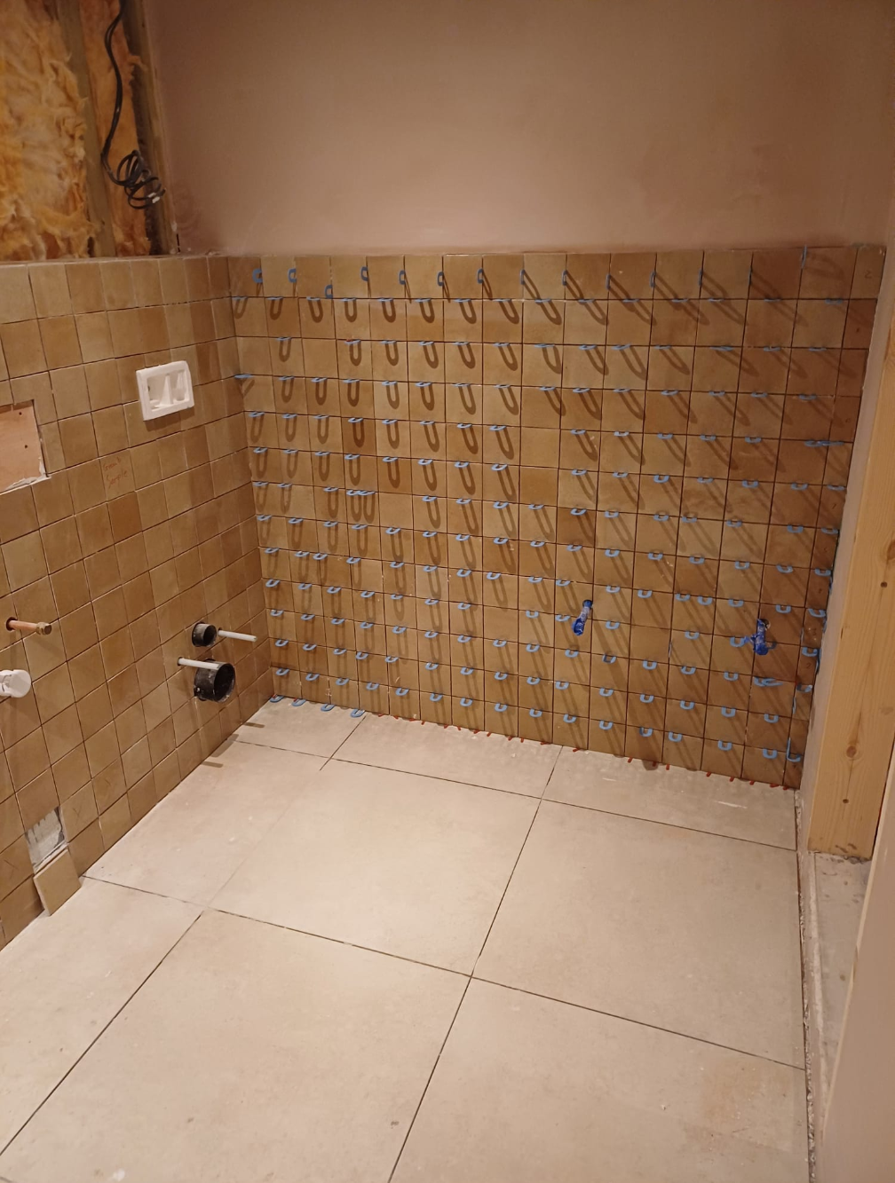 Bathroom wall tiling project in progress