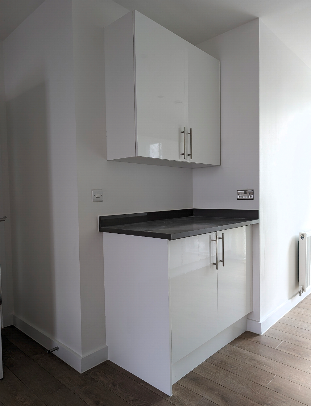 Modern kitchen corner with white cabinets