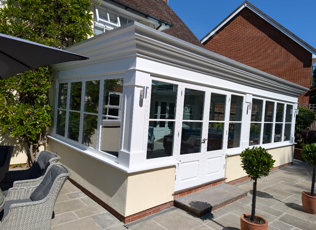 White orangery extension with glass French doors