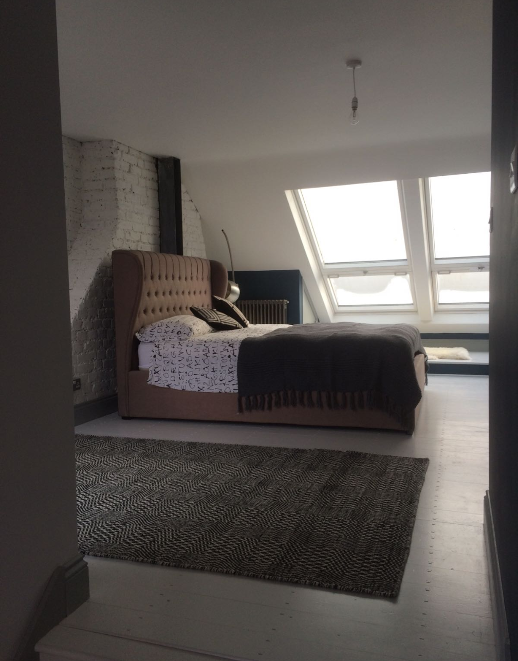 A stylish loft bedroom with large bed