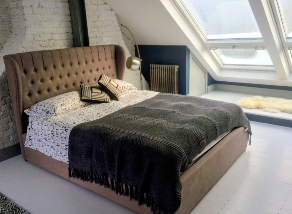 A cozy loft bedroom with a large bed